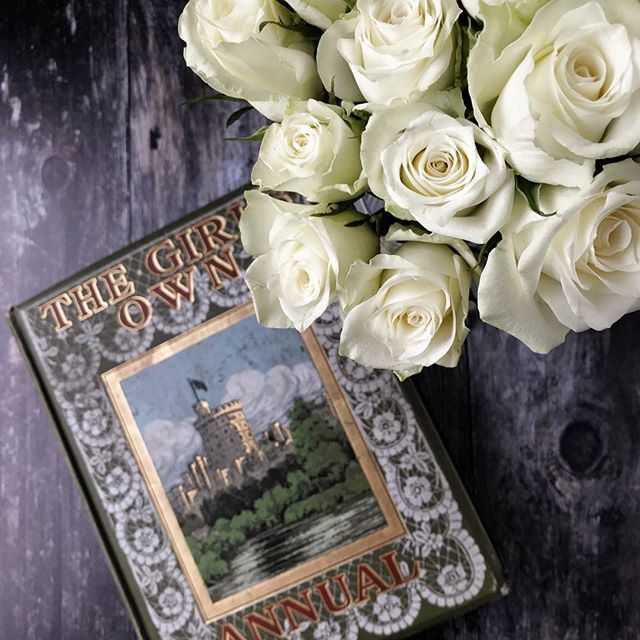 White roses and a vintage book