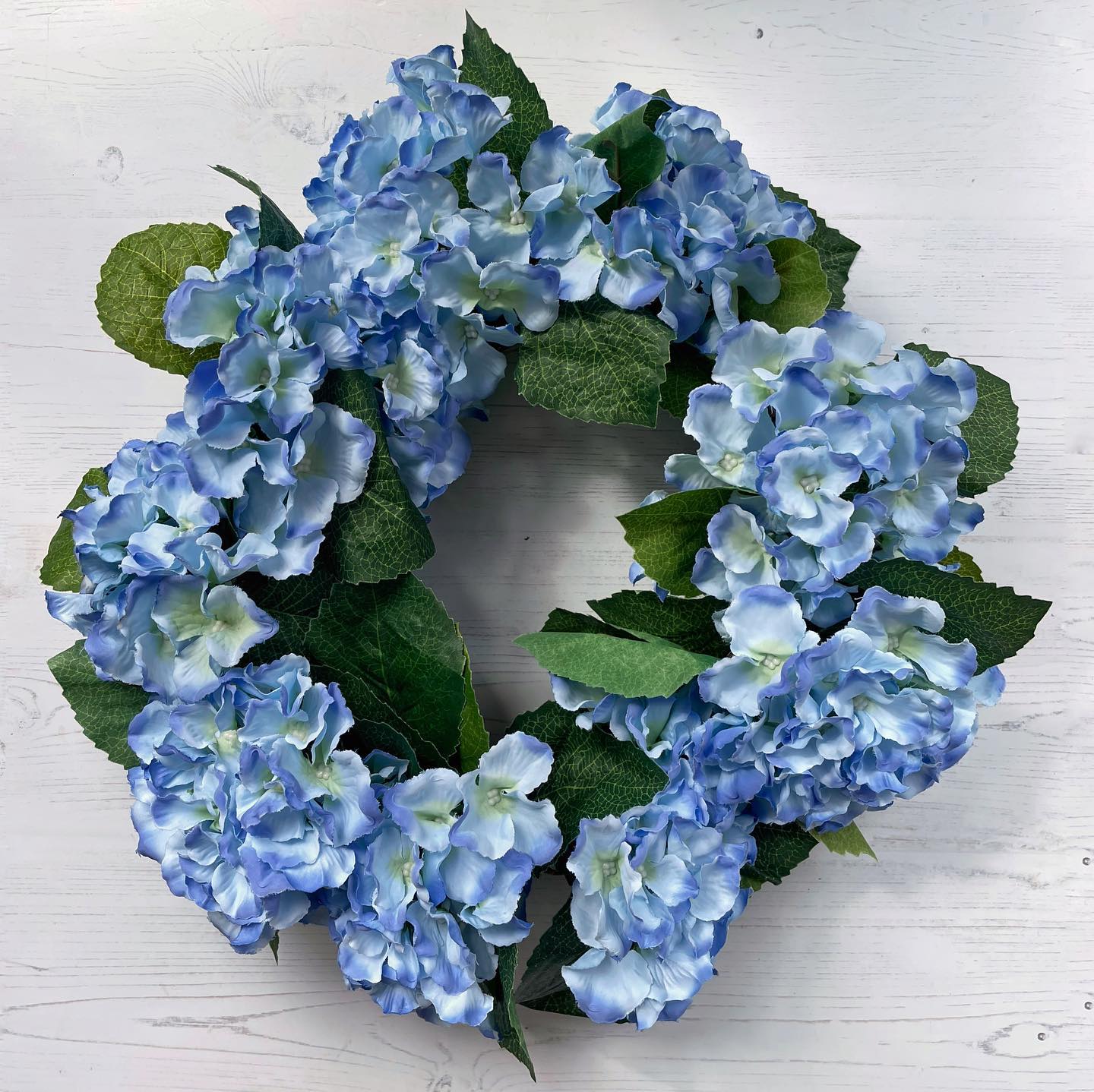 I created a blue hydrangea faux wreath …. hanging on to summer a bit longer!